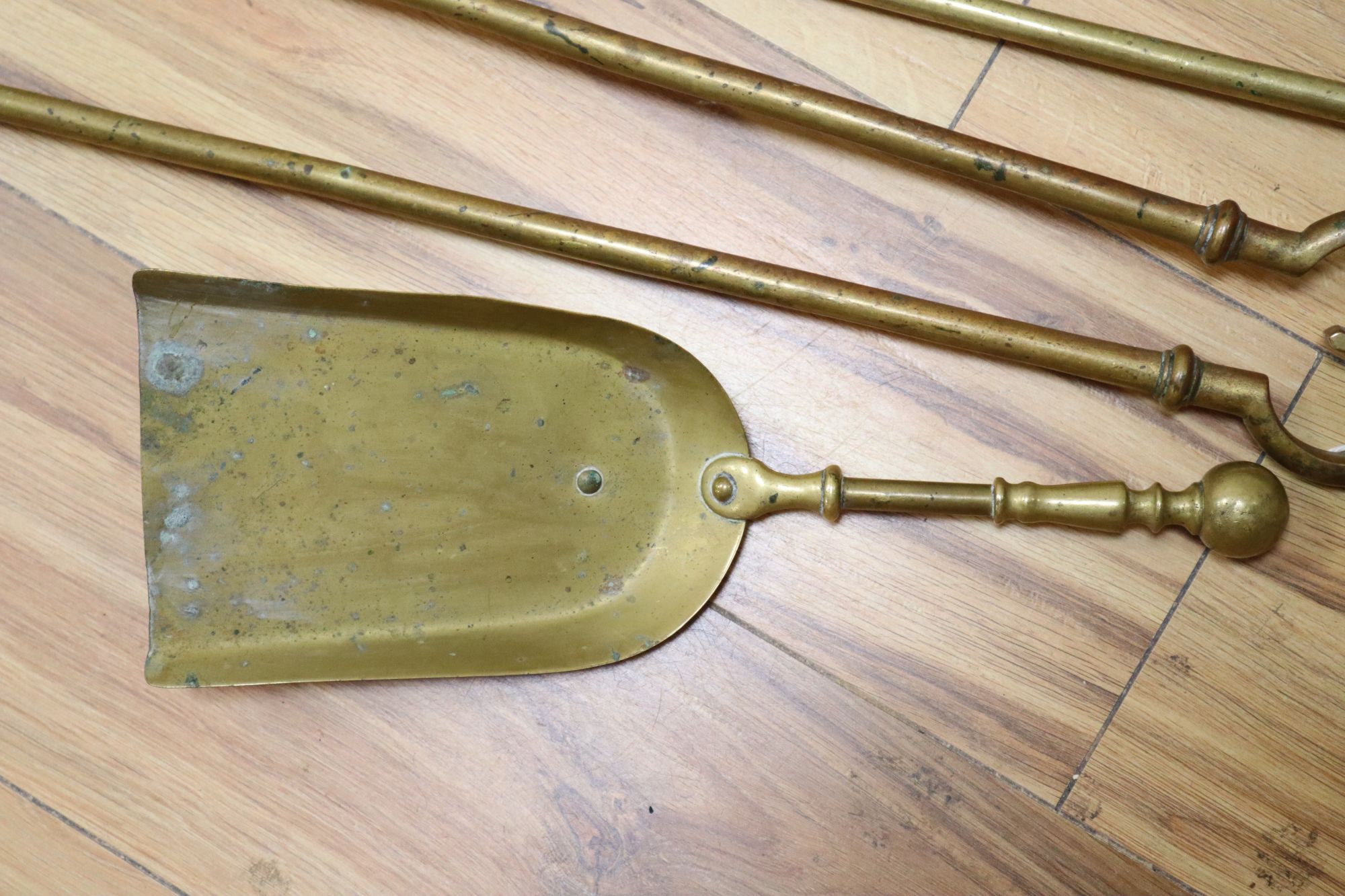 A set of three Georgian gilt bronze fire implements, a similar brass shovel and sundries,